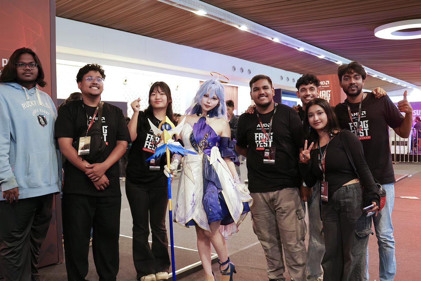 Local fans posing with a cosplayer at an event